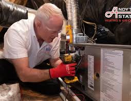 Service technician inspecting a furnace and its connections