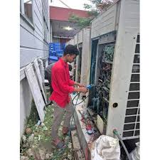 Service professional inspecting HVAC equipment controls